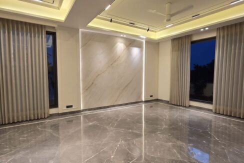 Windchimes Construction Empty Living Room Marble Feature Wall At Night - Builder