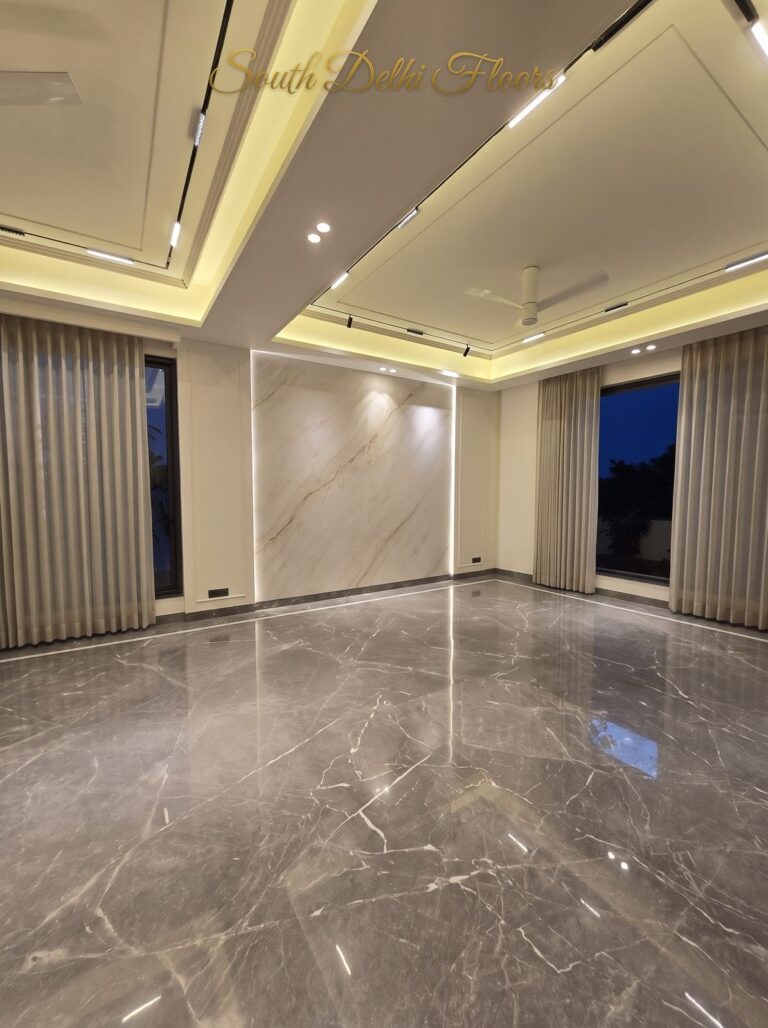 Living room marble feature wall at night at a Windchimes Construction builder floor in South Delhi