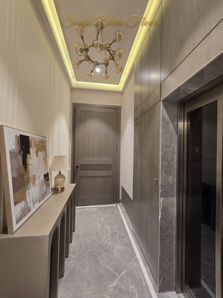 Lift lobby chandelier at a Windchimes Construction builder floor in South Delhi