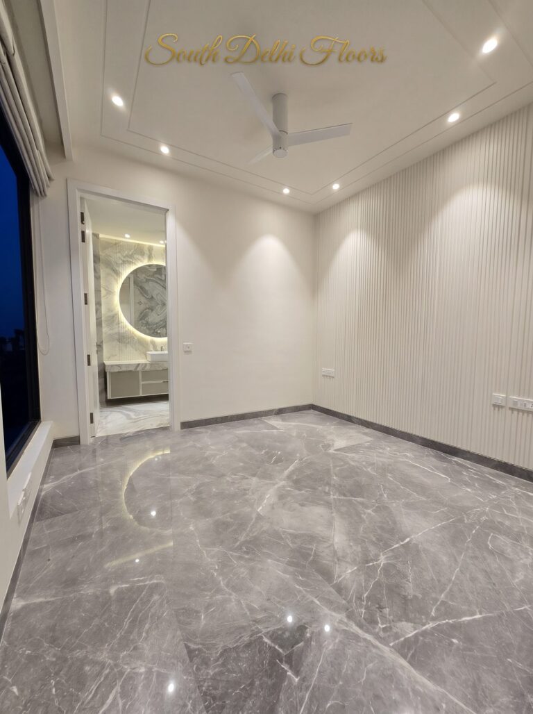 Bedroom backlit mirror view at night at a Windchimes Construction builder floor in South Delhi