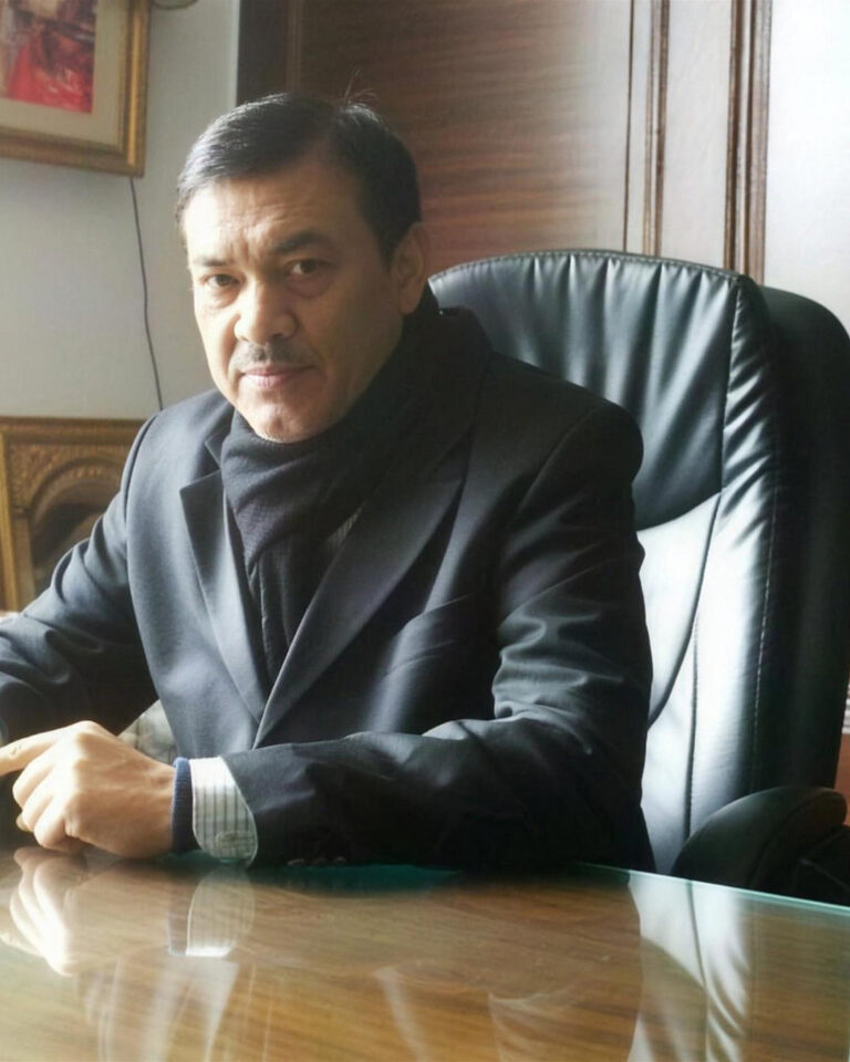 Rajesh Kumar Nandrajog, Director of Windchimes Constructions Private Limited, seated at his desk in the Vasant Vihar office